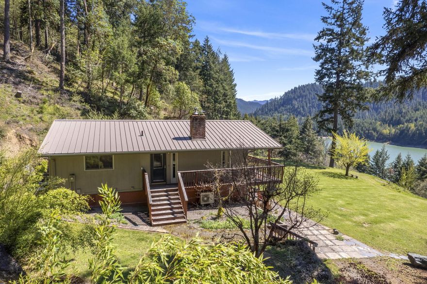 Nestled in a breathtaking natural setting, this comfortable two-story home offers beautiful views of a pristine reservoir. Sunlight pours into the great room, creating a warm and inviting atmosphere. Situated on an expansive lot that backs to a national forest, this property provides the perfect blend of privacy and outdoor adventure. The updated floor plan offers a great room with kitchen on each level, allowing for multiple use options. Details like wood flooring, updated kitchen, and nicely updated bathrooms will stand out. A spacious detached three-car garage adds convenience and ample storage. Whether you're seeking a peaceful escape or an outdoor enthusiast's paradise, this home is a rare gem waiting to be discovered!