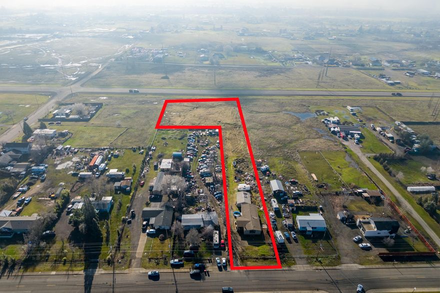 Incredible development opportunity!! Per County Planning, the WCUR-4 zoning on this two acre parcel allows for up to 8 HOMES!! Property can also be divided into multiple lots! Purchase at an entry level price, then build/divide when ready. Perfect for the owner occupant wanting space to stretch out, while staying near in-town conveniences. Two acres, 1848 sq.ft. home with 3BD/2BA + office, and 768 sq.ft. 3-car garage! Extensive room to park RVs and vehicles, work on projects, and let the kids run wild! Captivating views of Mt. McLoughlin from the front porch and yards. Great interior layout. Large living room separates the master suite and guest bedrooms from the office. For the late-nighters, family room with cozy wood-burning fireplace at far end of home- adjacent kitchen and dining room. Dedicated laundry room. Public water & sewer. Private well tested at 15+GPM in 1997- not currently connected to home. Look no further for your next real estate investment!