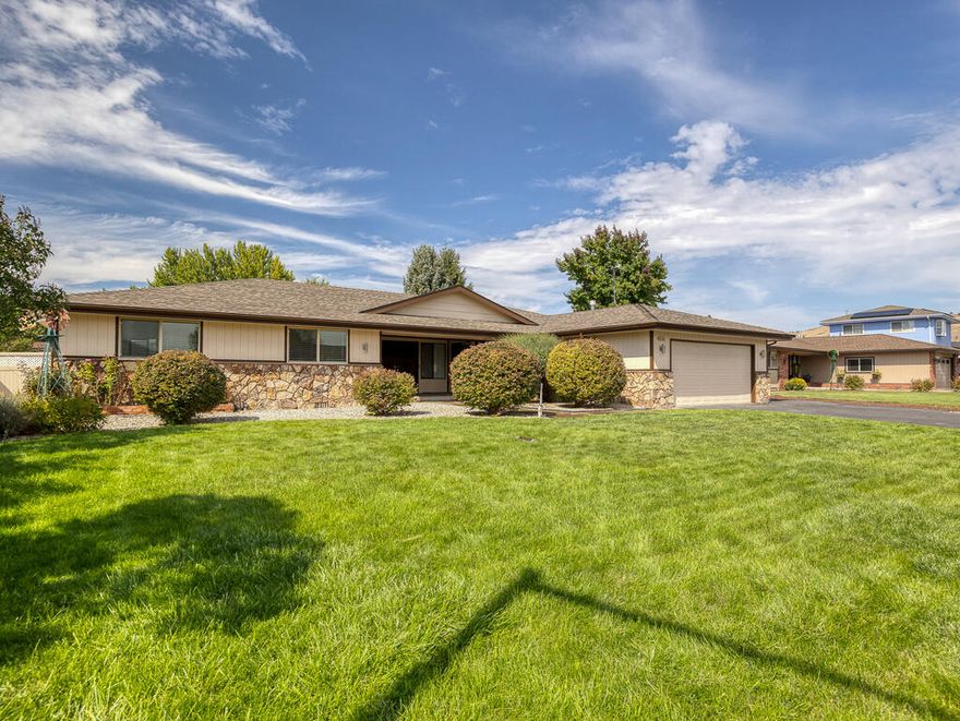 Motivated Seller! Charming 4-bedroom, 2-bath, home in desirable Sunset Village. Updates include new flooring, remodeled bathrooms, and a 2-year-old HVAC system. The bright wrap-around kitchen connects to the dining room, breakfast nook, and sunroom/patio. A spacious den with gas fireplace and large laundry room, add comfort and convenience. The primary suite features an en-suite bath and walk-in closet, with generously sized bedrooms throughout. Outside offers a landscaped, fenced yard with in-ground sprinklers, low-maintenance backyard, covered patio, garage with workshop, dog-run, and extra storage.