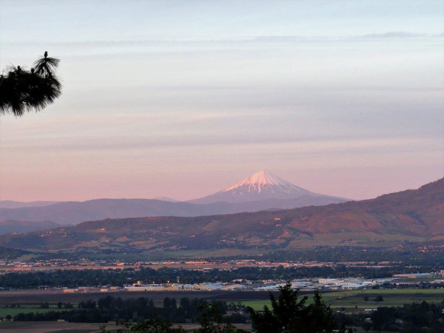 Spectacular views from this home! Perfect for a family, for those that like to entertain or if you just like to have a very spacious kitchen and relax on the large deck! The home is 3237 square feet with 4 bedrooms and 2.5 bathrooms. Picture windows to take advantage of such a great location! The fenced, in-ground pool is 8' deep! This property is located in the west hills between Jacksonville and Central Point. Paved driveway brings you up to the 3.12 acre property complete with a garden area and a small barn with water and power. In the kitchen you will find ample counter space, double ovens and a range/oven. Complimented with plenty of room for seating and even a bar with a sink, refrigerator, and ice maker. Large pantry and a half bath. Additional space for an office or a formal dining room, whichever fits your lifestyle. Just minutes to Jacksonville, Medford or Central Point for all your needs!
