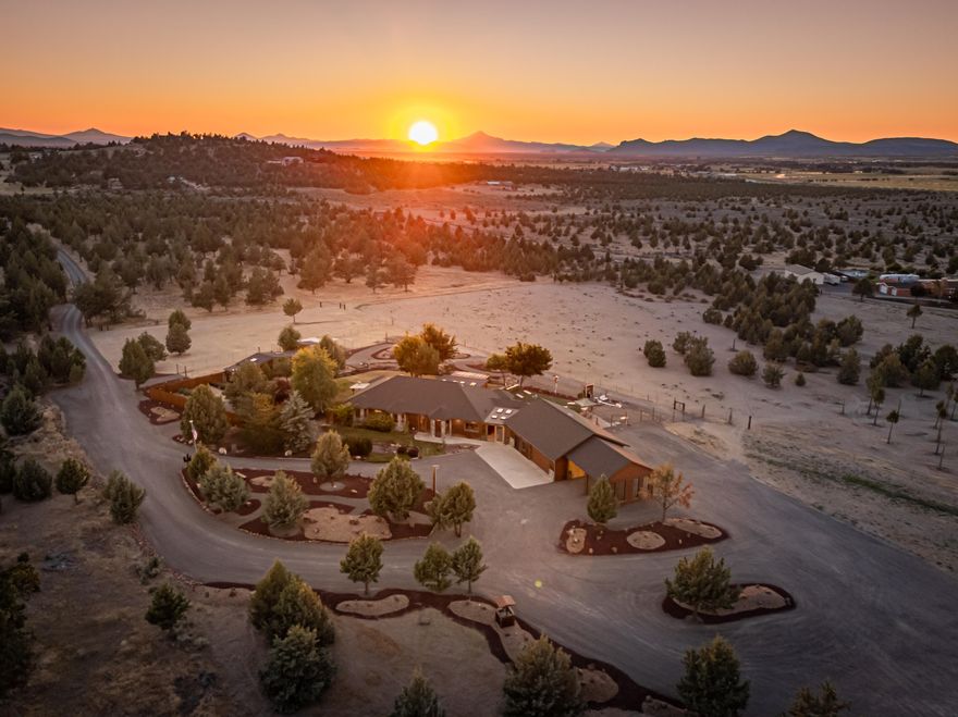 NEW ROOF and skylights 2025!!  20 completely private and fenced acres, with a stunning estate that offers everything you could dream of!  The main residence features an open floor plan with 10' ceilings, 4 spacious bedrooms, 3-1/2 bathrooms and an office, providing ample space for comfort and relaxation.  For the RV enthusiast, there are 4 hookups: 2 full and 2 with power and water.  Additionally there is a 36'x48' shop/barn that is ideal for storage, projects or animals.  Outdoor living is taken to the next level with an enclosed area that can be fully opened to enjoy Central Oregon year round. 
The green thumb in the family will enjoy the large greenhouse and garden area, along with a she shed and chicken coop.
Outside also features surround sound, firepit and horseshoe pit.  Parking is never an issue with a 2 car garage, carport and ample parking on the property for additional vehicles and equipment.   Stunning views of Smith Rock and Mt. Jefferson.