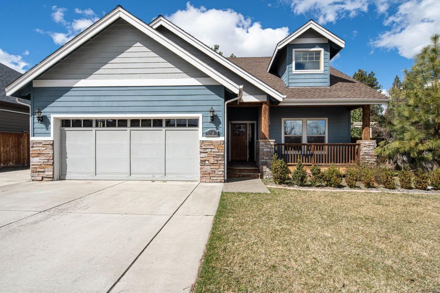 Discover this warm Bend residence in a pristine neighborhood, offering a private backyard located on a corner lot. This home exudes rustic elegance with stone and wood trim. On the main floor, you will find large vaulted ceilings in the living room, a robust kitchen with an island, a designated office space, and the primary suite, which is a retreat with a walk-in closet, separate tub, and an adjoining office. The large bedrooms and practicality shine through with a generously sized tiled utility room off the double garage. Your Bend sanctuary awaits!