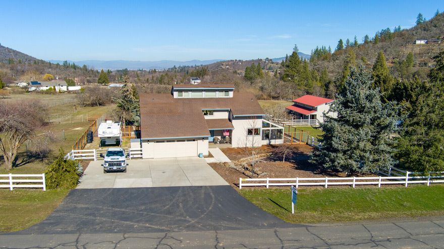 Check out the views from this horse lover's dream on 5+ acres w/seasonal creek. Featuring mature landscaping, this home offers an inviting front entry. Large windows to enjoy the breathtaking views through two-stories, enjoy the sunken living room w/ soaring ceiling & wood stove. The upgraded kitchen offers a dining area, breakfast bar, granite counters, & farmhouse sink. Just off the kitchen is the 12x16 sun-room w/double-door entry, tile floor, & sink. The main floor master features its own deck, 2 closets & en suite w/ shower and soaking tub. The upstairs has a loft area w/ tons of storage, 2 guest bedrooms & full bath. The backyard boasts endless views, a studio w/ a bathroom, a 30x40 insulated barn w/4 stalls, automatic waterers, 20' tack room, 15-ton hayloft, & access to a pen & pasture, surrounded by 5' horse fence. Owner's are finishing the back yard with mulch and it will be all ready for the next owners to enjoy! Ask for a list of the many upgrades!
