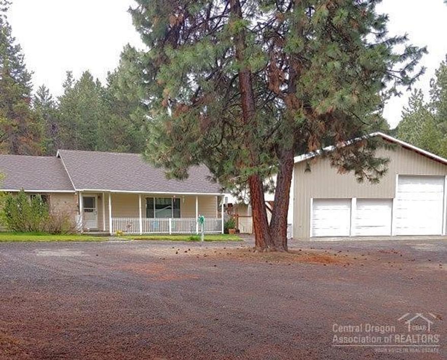 1728 sq' garage/RV enclosure with 4 doors (one 14' tall) and two that have pass through doors This spacious home has the WOW effect when entering with the open and flowing floor plan. 3 bedrooms 2 baths living room dining room and 20x20 family room. Vaulted ceilings, large kitchen with a wrap around island over- looking living room with ceiling to floor rock fireplace and dining room. New vinyl plank flooring through out most of home.. Shop has heated work room with work bench with another work benches. Circuit breaker for a welder, a loft for extra storage and an attached pulley. Mature landscaping, fenced and crossed fenced and gated. Underground sprinkler. Three outside buildings one insulated and has electric. Dog kennels. On a short cul d sac close to paved street.