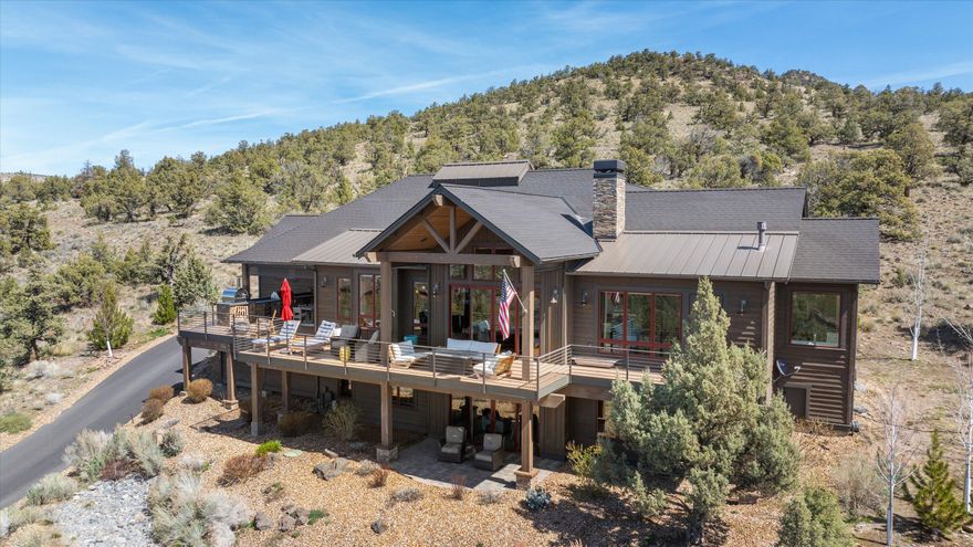 Take in panoramic Cascade Mountain views and the gorgeous sunsets famous at Brasada Ranch from the back deck that expands the length of this beautiful home. The deck features two gas fire pits, outdoor kitchen with pizza oven, and plenty of room for outdoor seating. As you enter the home you are greeted with warm sunlight through tall windows in the great room which lead to an open kitchen that provides ample space for entertaining with an island and butler's pantry. The main level includes Sonos surround with indoor/outdoor sound, an additional bedroom or office, spacious laundry room and the primary bedroom. The primary bedroom features a fireplace, two walk-in closets, soaking tub, heated floors, heated towel racks, and steam shower. Downstairs, you will find a bonus room, craft room, two en-suite guest bedrooms, with access to the outdoor covered patio. A large three car garage and views of the Powell Buttes from the front, complete this home.