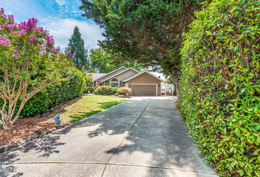 Prime East Medford neighborhood on a quiet cul-de-sac.
As if the location wasn't enough, this turnkey home is set at the end of a long, tree-lined driveway that makes it even more private and has tons of room for parking cars, RVs, boats, and other toys. The charming front patio leads into an inviting entryway and front living room with vaulted ceilings and a picturesque bay window. In the back is an open kitchen/dining area with a second living room and wood-burning fireplace insert, creating a cozy haven for when those chilly mornings finally come back. There is also a flex area that's perfect for a formal dining room, office, or homeschooling space. The huge back yard boasts a full-length covered porch, fire pit, pad for a hot tub, small garden area, and room to spare! This home is an ideal combination of size, location, and layout that the new owners will be lucky to enjoy and customize.