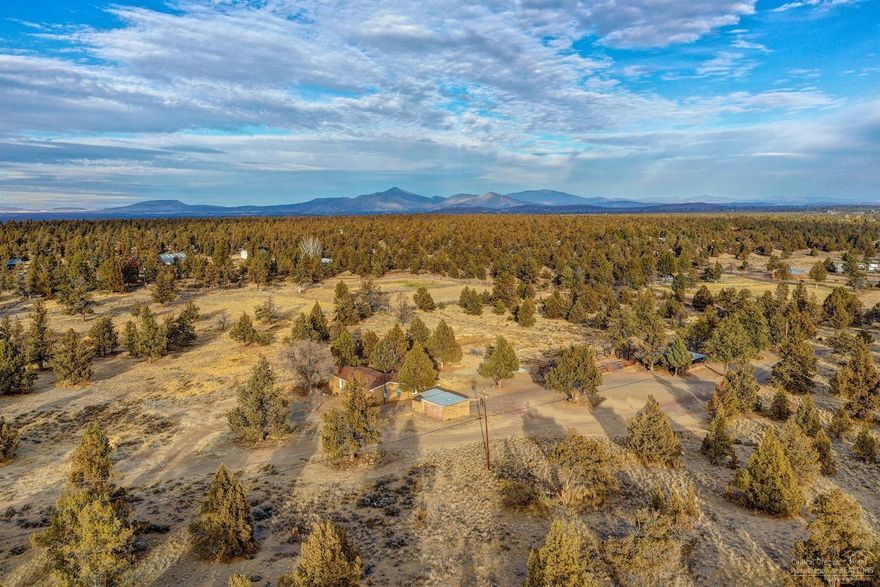 Located among juniper trees in a country setting, this NW Redmond hobby farm accommodates those buyers looking for privacy & elbow room while needing easy accessibility to Bend, Redmond & Sisters. This single level, open-concept floor plan offers a comfortable flow between vaulted living area & kitchen. The light & bright interior, terrain views from every window, & large deck for entertaining will not disappoint. Special features distinguishing this home are all the recent upgrades. Completed in Oct-new interior and exterior paint, flooring, doors, toilets, bathroom sinks, oven/range. A new septic tank in 2017, 30-yr roof in 2011, and new furnace & duct work in 2007. Additional qualities of the property include -2 stall barn w/ addnl tack/storage rm, fenced & cleared pasture, chicken-coop, storage sheds, 3 RV dump stations, private well, circular driveway. For those interested in adding an addnl 15-acres to this property, please see adjoining bare land parcel for sale MLS#201811048