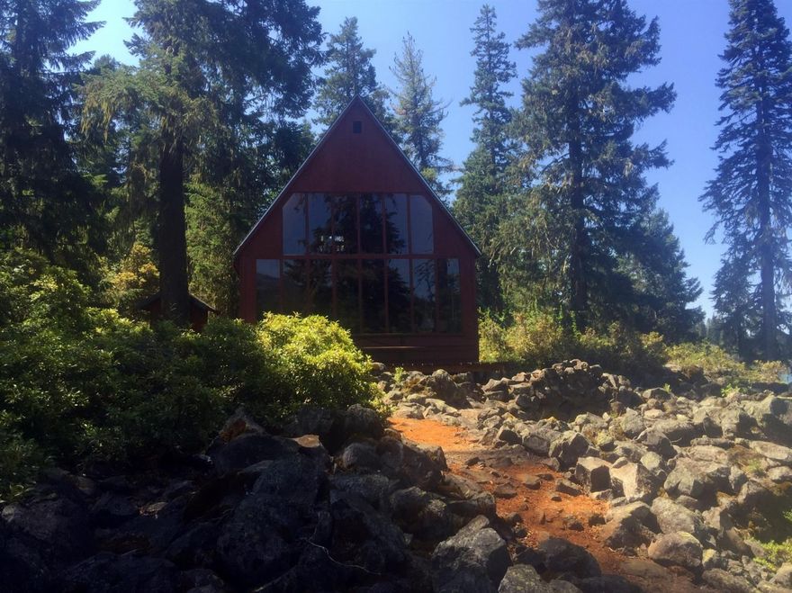 A simple furnished Lakefront cabin with stunning views in a picturesque setting on the south side of Fish Lake. Fish Lake is a 45 minute drive to Medford, so can be an ideal for a busy professional that needs to stay close to town, yet craves adventure and appreciates nature. Mount McLoughlin dominates the skyline from the North facing wall of windows, the front deck, and the private boat dock.Additionally, the cabin is situated in a way that has enables a rare and expansive view of the lake that extends over 180 degrees, from Southwest to Northeast! The A-frame cabin has a kitchen, living room, and a loft bedroom, served by a wood burning stove, and electricity. A modest cabin with boat access, a shed, and an outhouse.This purchase does not include real estate, the property is on a land lease with the Forest Service, which costs $2180 annually. Property taxes were only $211 in 2016. Surrounded by towering trees, unbelievable views, lava rock, the Lake & osprey. Requires appointment.