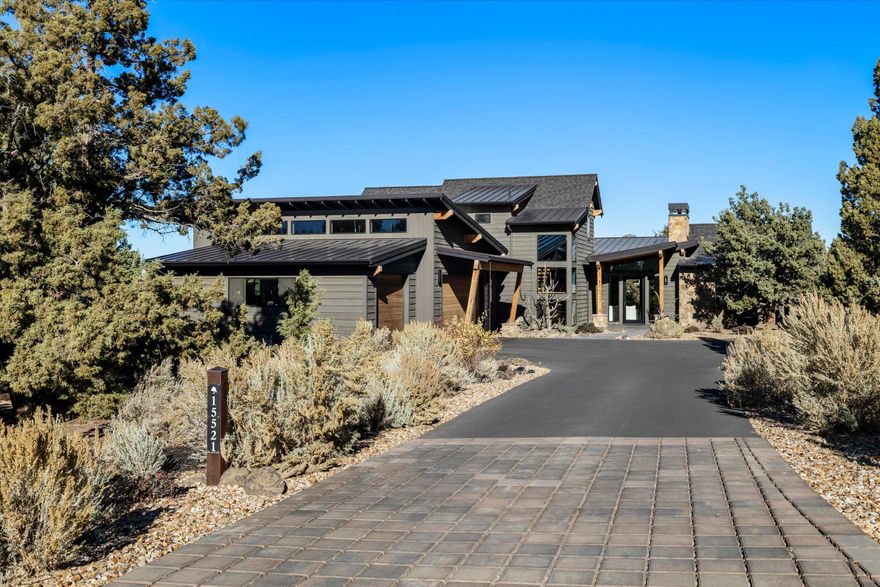 This stunning 4 bed/3.5 bath home represents a woven tapestry of natural materials blended w/ Mountain Modern clean lines that culminate to harmonious Brasada living. Perfectly positioned home that blends a private, juniper infused, organic barrier & features exceptional views of the Cascade Mountains. Inside, this home continues the rustic modern vibe w/ openness & finishes that flows through to the outdoor kitchen, complete w/ a pizza oven, & covered patio w/ a stone fireplace to enjoy the outdoor living year-round. The open floor plan boasts features like a kitchen w/ a large island for entertaining, stainless-steel appliances, & walk- in pantry. The primary bedroom, located on the first-floor w/ a kitchenette, private access to outdoor patio, walk-in closet, & spacious tiled shower. There's an office, additional bedroom w/ bath & half bath, utility room & 3 bay garage on the first floor. Upstairs you will find, bonus room w/ bunk bed-built ins, full bath, & a rec room w/ Mtn.views