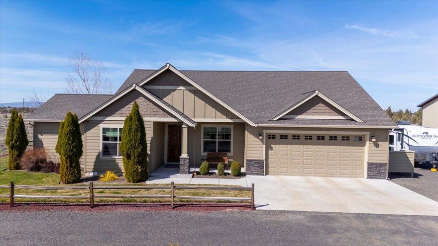 Crooked River Ranch retreat! Exquisite single-level home nestled on a 5-acre level corner lot boasting breathtaking views of the Cascade Mountains - Mt. Bachelor to Jefferson. Inside you will find a thoughtfully designed interior with premium finishes: wood flooring, granite countertops and rich walnut-stained cabinetry. Floorplan includes 3 spacious bedrooms & a versatile office/ TV room. Experience optimal bedroom separation, each with walk-in closets. The expansive primary suite impresses you with its vaulted ceiling. Ensuite bath offers tile flooring, tile shower, double vanity, a separate water closet and built-in storage. Attached oversized garage + 1440 sf RV shop/garage with 2-14' doors & 1-12' door.  Enjoy peaceful mornings or evenings on the charming covered front porch or the expansive covered rear patio with amazing views. This property is more than just a home - it's a lifestyle waiting for you to embrace.