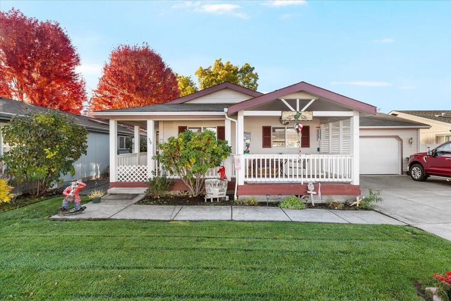 Located in the Miller Estates 55+ Community, this 2001 manufactured home offers approx. 1,450+ square feet of comfortable living space. It features 2 bdrms, 2 bathrms, & a 3rd room that can serve as a den/office, complete w/a closet. The home includes an attached, finished 2-car garage w/a workbench, utility sink, & cabinets. Relax on the covered front porch or the spacious 14'x22' covered back patio. The landscaped yard is easy to maintain w/a timed sprinkler system in both the front & back. Updates include a 2012 roof, new flooring in 2024, and stunning granite kitchen counters w/ a breakfast bar and ample cupboard space. The dining area boasts a large window & there is a separate laundry room w/access to the oversized garage. Vaulted ceilings, ceiling fans, and double-pane vinyl windows enhance the home throughout. The guest bathrm has a tub/shower combo, while the primary bathroom features a garden tub & separate shower. Miller Estates has its own private park.