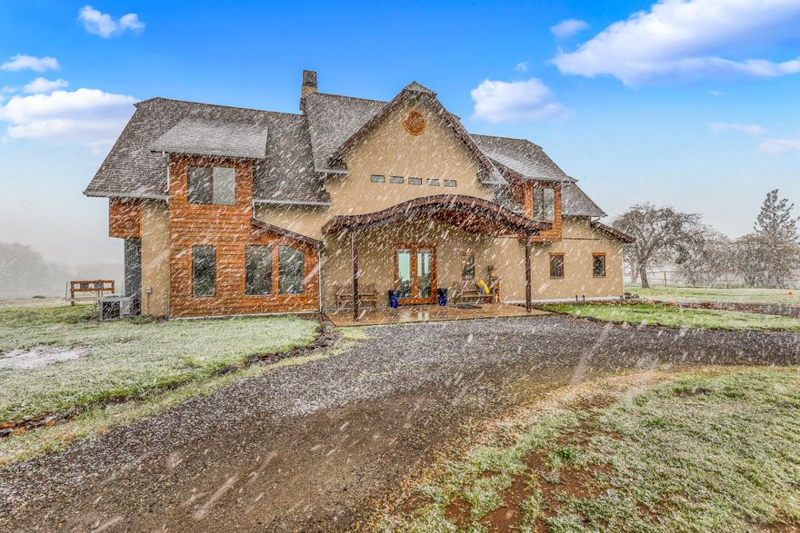 Priced to sell!  This unique 4,069 sqft modern-industrial home was custom built in 2017, perched on 24.37 acres of EFU land.  Great for entertaining, or a two family setup with the ADU space above the 4-car garage.  Walking in, you'll find the house open up dramatically with it's incredible 18' ceilings, with floor to ceiling windows lighting the house up.  In the kitchen, you'll find a commercial kitchen with two dishwashers, a Wolf range, and quartz countertops.  Finishing out the main level, are two bedrooms including the primary suite overlooking the pastures.  Moving upstairs, a spacious balcony/loft space leads you to the two additional bedrooms and bathrooms.  The 1,008sqft ADU above the garage has plenty of space to be customized to fit your needs.  The land is mostly flat with two seasonal ponds, and a seasonal creek.