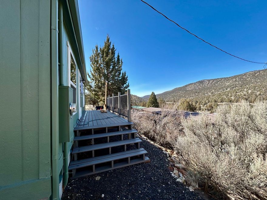 Don't miss the opportunity to own this 2 bedroom 1 bathroom nestled on 2.83 acres of serene, picturesque land, this charming manufactured home offers the perfect balance of comfort and tranquility. With stunning mountain views as your backdrop, the property provides a peaceful retreat from the hustle and bustle of daily life. The home features an open-concept floor plan that maximizes space and natural light. Step outside to enjoy the expansive outdoor space, ideal for gardening, entertaining, or simply relaxing. Whether you're looking for a peaceful getaway or a place to call home, this property is a true gem. A detached metal carport offers ample space to park your recreational toys, while a convenient circular driveway provides easy access. The property also includes a small greenhouse. Home is being sold ''AS-IS'' seller will not make any repairs. Call your realtor for a showing!