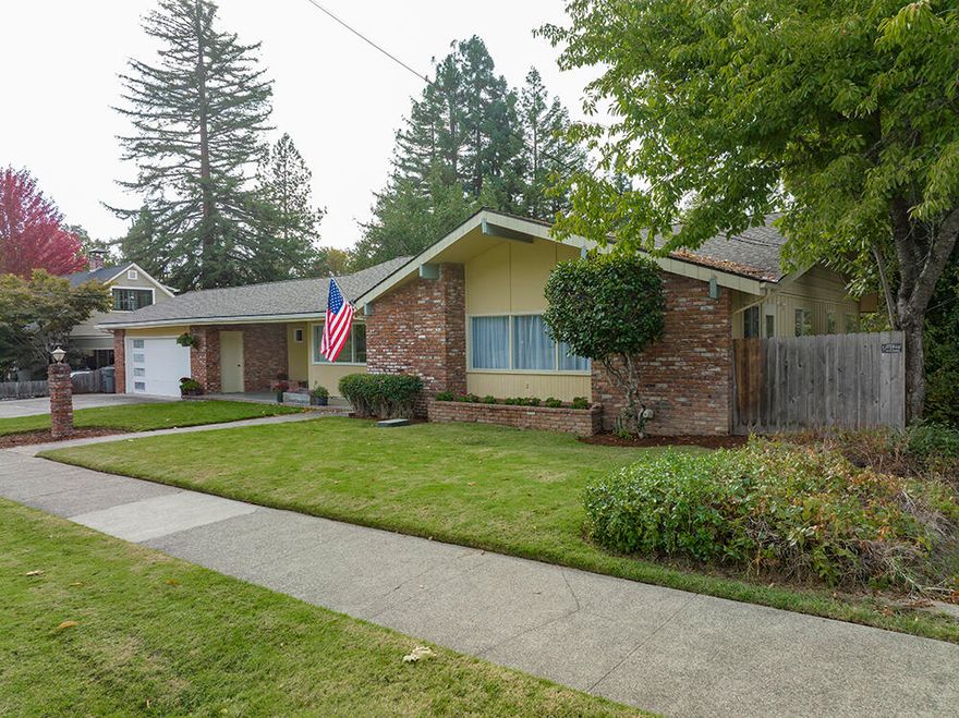 Fantastic 5 Bedroom 3 Bath Home on a Huge Oversized Lot in Desirable NW Grants Pass! Lawnridge Avenue is right in the Heart of Quality Historic Homes, & within Easy Walking Distance of Parks, Schools, & Seasonal Events that take place here. This Spacious Home offers an Attractive Floorplan, including a Main-Level Master, a Huge Great Room that offers an Updated Kitchen with Stainless Appliances, Island & Pantry, Two Guest Rooms & Bath, Large Living Room & Separate Office! Pretty Laminate Floors in the Great Room provide a Contemporary Look. Downstairs you will find Two Additional Bedrooms, a Full Bath, & an Awesome Family Room with Fireplace & Access to the Rear Patio. The Huge Fully-Fenced Rear Yard offers a Garden Area & Storage Shed. Attached Two-Car Garage, plus plenty of Off-Street Parking. This is an Amazing Value for the Sq. Footage & Bedroom Count. You can't beat the Location! Perfect for a Large Family or Multi-Generational Living, this Home is Super-Clean & Move-in ready!