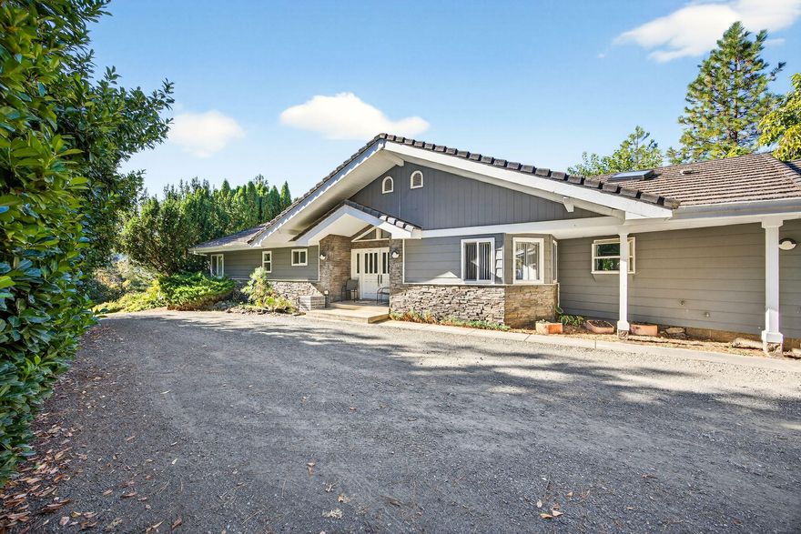 Nestled on 20 peaceful acres with sweeping valley views, this beautiful 3-bed, 2-bath home offers the perfect blend of privacy, space, and rural charm. Built in 1990, the residence features an inviting open floorplan with expansive windows that flood the interior with natural light and frame breathtaking scenery. Enjoy irrigated pasture ideal for horses or livestock, a large shop for projects or storage, and a covered RV shed for extra convenience. Solar backup power provides added efficiency and peace of mind. Located just 13 minutes from historic downtown Jacksonville and only 5 minutes from the Applegate Store, this property places you in the heart of Southern Oregon's renowned wine country. A wonderful opportunity for families, hobby farmers, or anyone seeking tranquility and self-sufficiency with modern comforts — the perfect retreat to live, work, and play in one of the most picturesque valleys in Oregon.