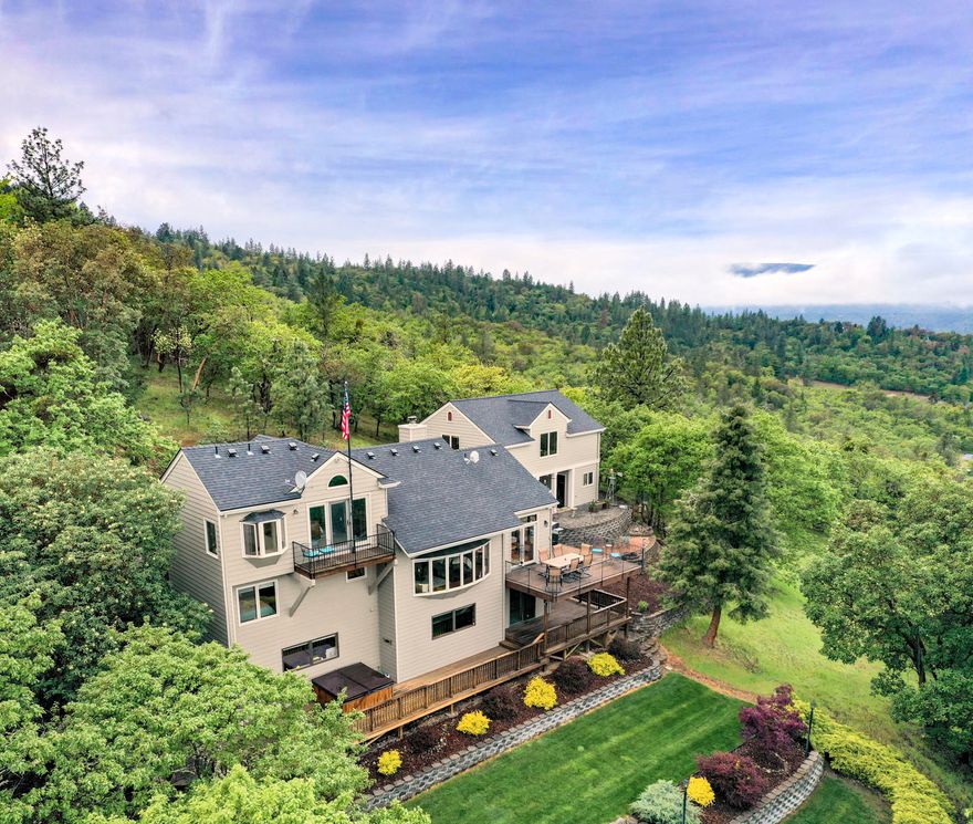 Ridge top Craftsman Style home on 4.97 acres with stunning views of Rogue Valley, Mt McLaughlin, Table Rocks and city lights. Feels secluded, but only minutes from Historic Jacksonville & DANCIN Vineyards. Total sq ft is 3438, main house is 2622 sq ft and above the two-car carport is another 816 sq ft. Main house includes 4 bedrooms, 3 full baths with 1556 sq ft of deck for entertaining & enjoying the views. The upper master bedroom suite has a balcony w/view,
walk in closet & spacious bathroom. Living room offers open floorplan, awesome views, vaulted ceiling & woodstove. 2 bedrooms & full bath on same level. Lower level offers large family room/bedroom, office, full bath & spacious storage area. Recent improvements are exterior paint, new roof, landscaping, new well pump, new septic tank & more. Above two-car carport is the 816 sq ft bonus room which is perfect for mancave, home office, media or rec room & it has HVAC system and full bath. Excellent well water. RV Parking.