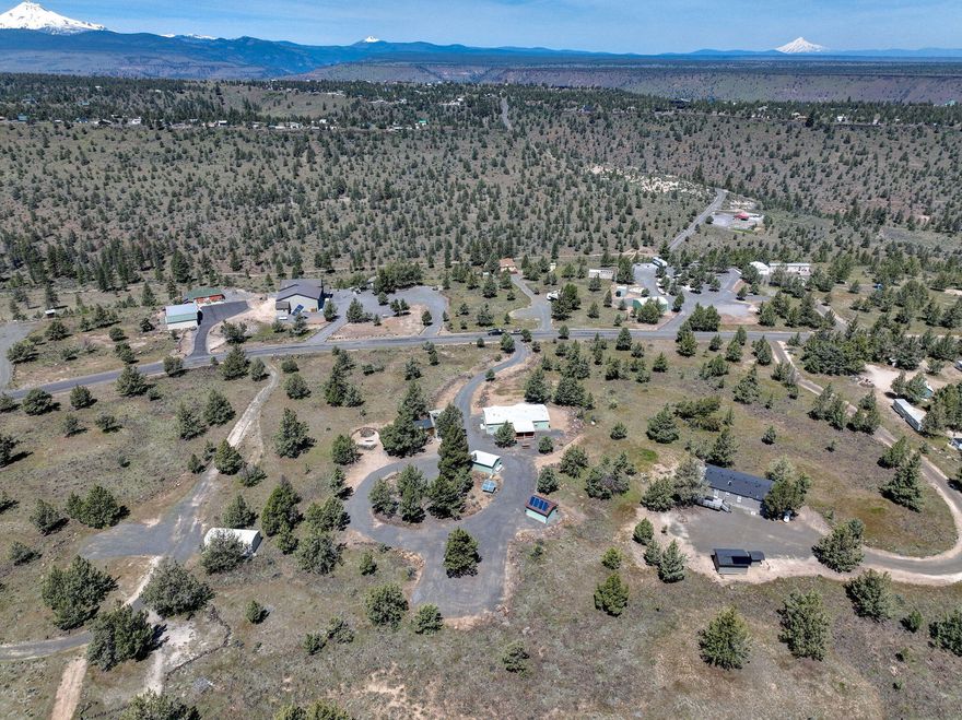 Lot's of pride in ownership this neat and tidy 2.65 acre property offers three bedroom two bath1404 square foot manufactured home. Move-in ready for full-time living or use as a second home. Sit in the living room and enjoy Beautiful Cascade Mountain Views. Entertain on the covered back deck. Circular driveway for family and guest trailer parking. Furnishing can be included in the sale. Property features a 2500 gallon cistern, all solar systems in owned. Come in enjoy all the amenities that 3 Rivers as to offer. Dirt bike and ATV trails, private beach on the Metolius River. Gun Range, community center. Pickleball court. Private Air Strip.