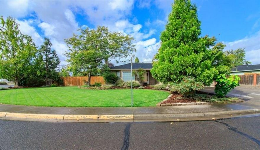 Charming contemporary home with new paint inside and out on a large corner lot. Features Bay window, fireplace, and upgraded to LED lighting. Lots of closets and storage. Newer roof, and updated heating system. New grass in the front yard, as well as new fencing, this home shows pride of ownership. Includes RV parking with extra wide access and hookups, 6-stage sprinkler system, and brand new stove/oven. This home is move in ready for the next family!