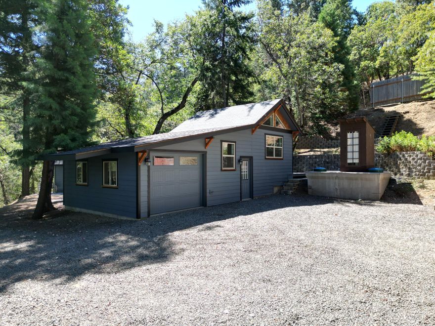 Bare land w/ extras, close to town yet feels like your own private wooded escape. 2.15 acres on a beautiful hillside w/ tons of leveling work done. Gated shared access, down the left side of the fork to the 1st level. First level has a leveled approved homesite. Also is the well pump building & holding tank. 2nd leveled area is a permitted stunningly set up outbuilding w/ an oversized finished 1 car garage. Just beyond the outbuilding is a custom built permitted sauna & a certified woodstove. Just behind the sauna is a seasonal pond, pipe fed from an upper creek located on the property from Mt Ashland snow melt. Medium sized solar vented greenhouse, capped off septic tank, finished outbuilding w/ a toilet w/ running water from the gravity fed well. Lastly there is a metal storage container & what the seller calls the pond shed. This property will not disappoint and is highly ready for the next owner to make it their forever home in the woods.