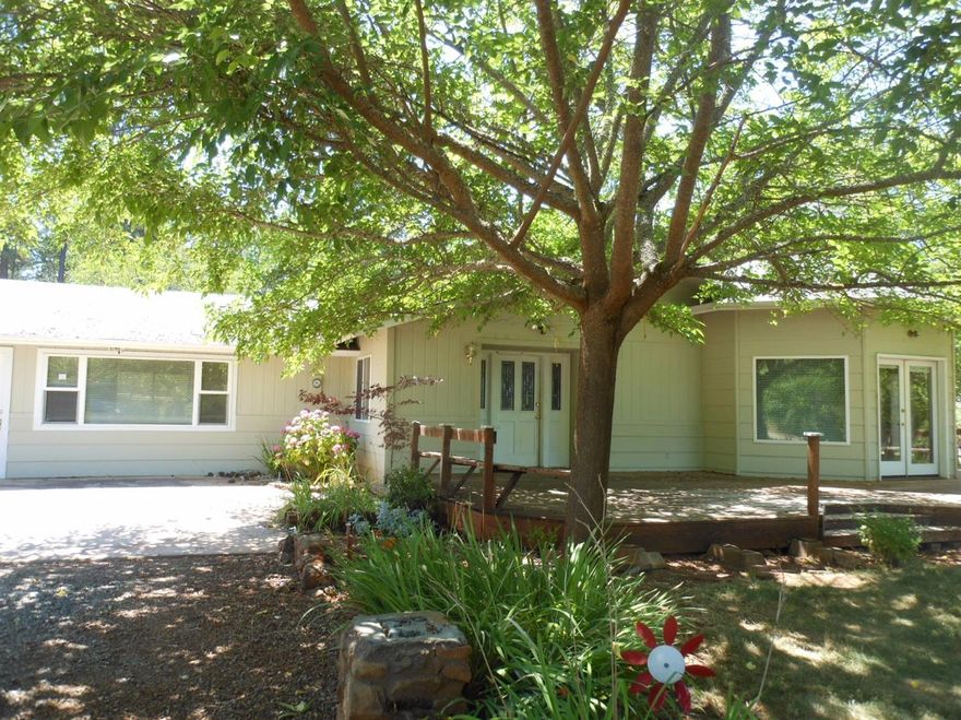 Nice secluded property, 8.87 usable acres with mature landscaping and fruit trees. The home has 2 bedrooms, 2 baths, approx. 2123 square feet with hardwood floors and great front deck to enjoy the peaceful surroundings. There is a 48x40ft metal barn with a concrete floor, solar electric entrance gate, attached two car garage and plenty of RV parking. This property would be great for horses! Home has very spacious living room with separate family room, kitchen with abundant storage including wood cabinets with 4 lazy-susans and 2 pullout spice cupboards, and master bedroom has large walk-in closet and jetted tub. All information is deemed reliable but not verified; anyone considering purchasing this property should perform their own investigation into the uses and condition of the property.