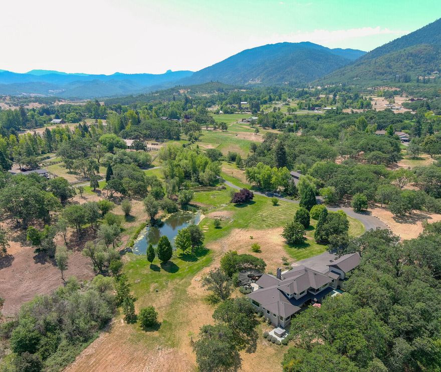 This is a one of a kind estate just minutes from downtown Ashland. There are 3 homes and a studio apartment on just over 20 acres with Irrigation rights, two tax lots zoned EFU, The property also features 2- spring fed ponds, creeks running through the property, 6 stall barn with fenced pastures, orchard, lush open space. All with extreme privacy and views of the mountains. 2 wells producing ample water. The 2001 custom stone house built by the Shostrom Bros is a masterpiece that features 2,500 sq ft 2 B/R 2/1BA, exposed timbers, 22 ft open beamed ceilings, stamped concrete floors, custom mill-work, incredible kitchen, garage with studio/home office. The main house, built in 2002, features 3,545 sq ft , 4 BR/4BA, with everything you need in a home. High ceilings,  fireplaces, large master bedroom and bathroom, bonus space, great private office above the oversized 2 car garage. Original ranch house is 1,324 sq ft , 2 BR/2 BA. Separate Art Studio also included.