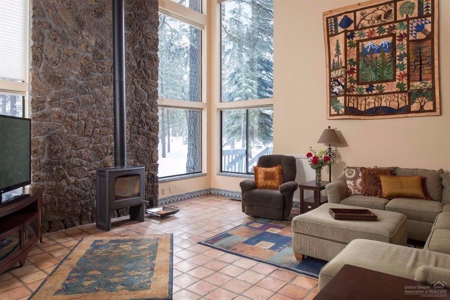 This custom built, 3,200 sq ft home is surrounded by mature landscaping in a private cul-de-sac, close to the river. Elegantly updated kitchen & master bath w/ slab granite, natural stone tile & alder cabinets. Great room w/ exposed cedar/beam ceiling, giant picture windows. Generous master suite on main level has vaulted ceiling, wood burning stove & private deck. Upstairs: Large bdrm + 2 add'l bedrooms perfect for kids & a loft overlooking the great room. 2 full baths & 2-half baths. Hot Tub.