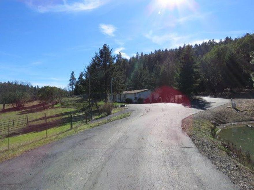 The gated entry with paved driveway adjacent to a large bass pond takes you up to a 1991 Golden West 1620 sq. ft. home, with 2 bedrooms and 2 baths. The 1232 sq. ft. detached finished garage features an attached shop with heat & air conditioning, plus a 12 x 40 covered lean-to. Plus there is an additional 1120 sq. ft. 2 bay RV garage with roll-up doors and another 14 x 40 covered lean-to for those toys or equipment. There are 2 good sized ponds. The home features an open floor plan with vaulted ceilings. There is a skylight in the kitchen and a solar tube in the guest bathroom. Double sinks, a shower and jetted tub completes the master bathroom. Wonderful views from anywhere on the property; home sits way back off of Sterling Creek. Do not go beyond property on driveway, private property above. If your client is looking for rural property this has to be on your view list!