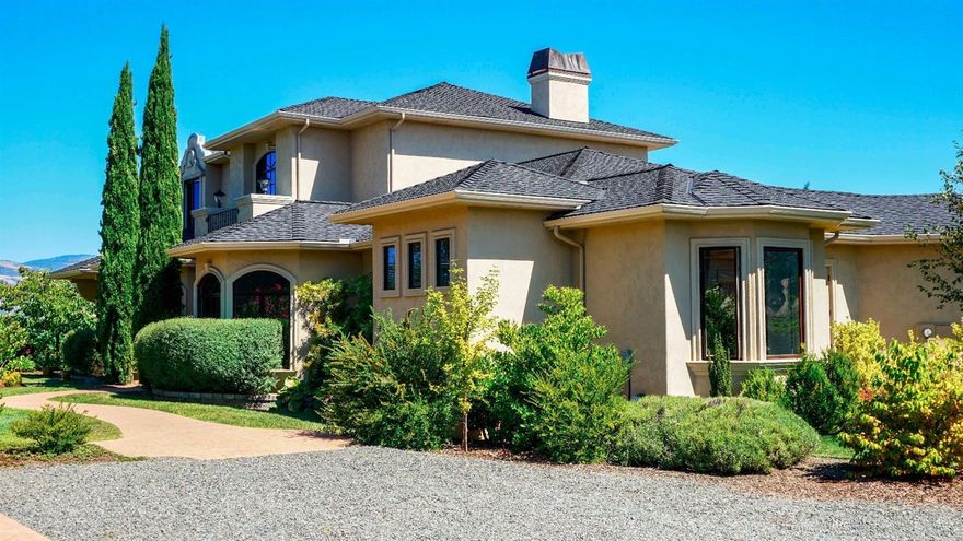 Located in beautiful Southern Oregon, Carpenter Hill Estate and Vineyard is the ideal place to enjoy all that the region has to offer. The wonderful custom estate captures the very essence of the vineyard dream with dramatic views, and elegant details throughout. The Mediterranean Style house was custom built in 2006, by Michael Pagnini. The stunning home features huge vaulted ceilings, arched entryways, and stunning detail in each room! The custom Sierra Pacific wood casement windows provide an abundance of natural light as well as breathtaking views from nearly every room. The living room boasts 20 + foot ceilings, a gas fireplace, hardwood floors and built in cabinetry. The gourmet kitchen features beautiful wood cabinetry, granite counters with raised eating bar, beautiful tile backsplash and genuine copper sink. Quality stainless appliances include a 48'' Viking range with double oven, 6 burners, griddle and custom built-in hood, Sub-Zero refrigerator, cabinet faced dishwash