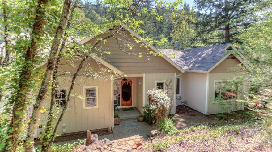 Own your own waterfall directly in front of your house on 7.11 acres of totally secluded park like setting! This custom home is located just two blocks outside the Ashland city limits. The home offers 2600 square feet and 4 bedrooms and 2.5 baths plus den with lots of amenities that include, handcrafted Klamath River rock fireplace, timber frame construction living room, 9' vaulted beamed ceilings, hardwood floors, open floor plan, master suite on the main level and antique vintage interior doors. Recent upgrades include the heat/air system, thermostat, most of the interior and exterior paint, refinished hardwood floors, and more. You will love the creek, waterfall and sitting area near the creek. This is one of the most unique and beautiful properties in southern Oregon that should not be missed.