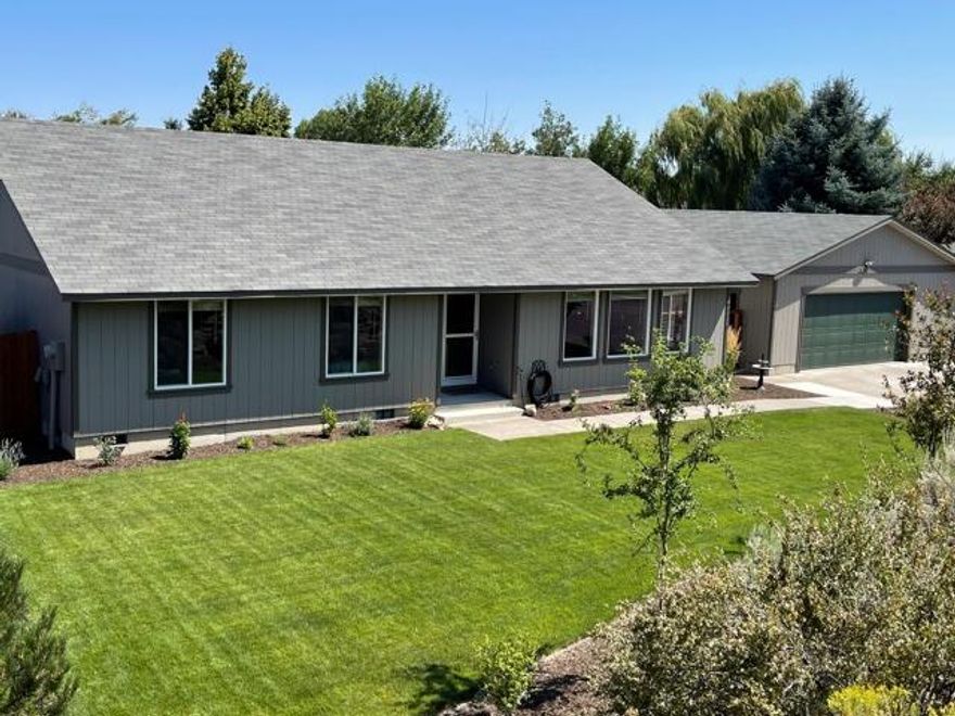 Single level home w/ 840 sq ft detached garage tucked away on dead end street next to common space for extra privacy. Ton of upgrades since purchased in 2019: vinyl plank flooring, gas, gas fireplace, ceiling fans, light fixtures, interior paint, bathroom vanities, blinds, baseboards, appliances, concrete pad & walkway, new wood deck, landscaping, irrigation, & shed. New roof, fresh exterior paint 2021. Vaulted ceiling living area nice and bright with lots of windows. Huge driveway with room for toys, RV parking, plus RV drain hook up. Raised planter beds in back yard. Hot tub ''as is''. Easy access to HWY 97 to get anywhere in town quickly.