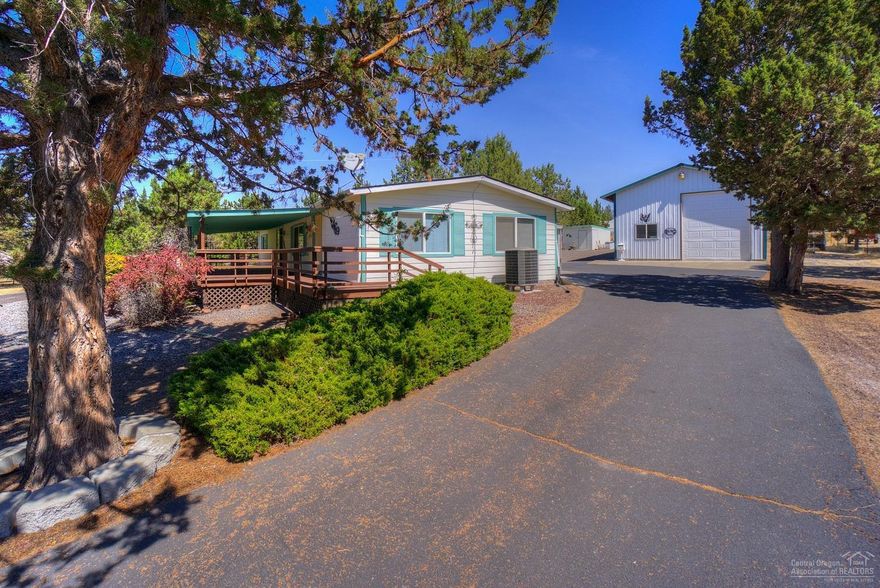 Serenity awaits! Very well kept home in the heart of CRR. Gated & paved driveway to spacious 3br, 2 ba home w/private Master Suite. Two living areas, formal dining, 2nd bedroom w/bath access, mud room & tons of storage. Like NEW roof, exterior siding & paint. Carpeted & tiled floors. Covered deck, carport, store room, outbuildings and SHOP! RV garage w/loft over insulated hobby & tool room, addit'l car storage w/gate doors, tool shed & greenhouse. Peekaboo Mountain views, low maint. landscape - ready to go!