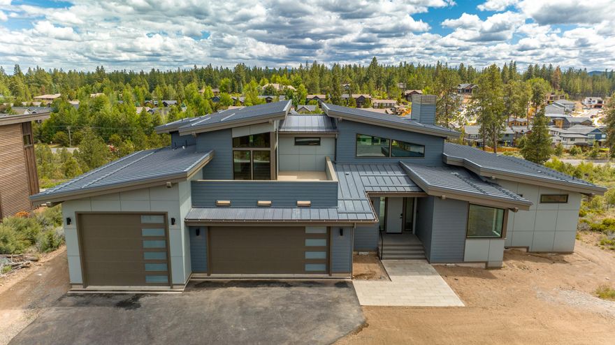 Bring the outdoors in with this enveloping home offered from the minds of Shelter Studio and the hands of Brashear Development. The home is fully automated and is Earth Advantage Gold Certified. Built utilizing steel elements throughout the framing, It makes for a a grand entrance and a very unique living space. Mountain views abound throughout the home. Rest easy in your ground floor primary suite with heated floor main bath with curbless shower and soaking tub. Entertaining is easy with a full set of Thermador appliances throughout the kitchen. Warm yourself and guests on the back deck next to a large steel fire pit and in your on deck hot tub. Parking and storage is plentiful with a 3 car garage featuring an 11 foot RV garage door with 29' bay. Enjoy everything the Tetherow community has to offer, with world class golf, fitness, and member facilities. Listing broker is business associates with builder.