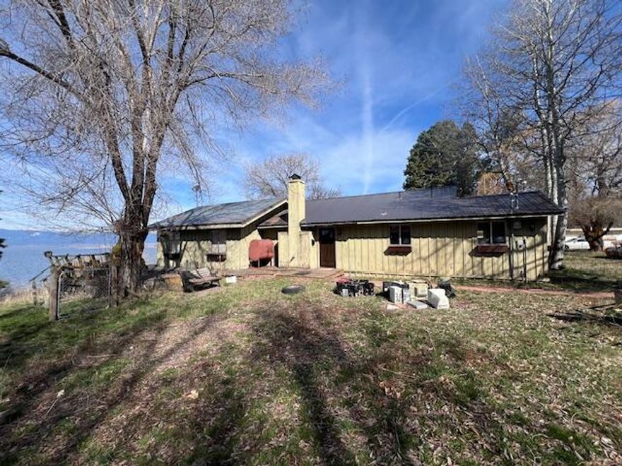 🏡 Rare Opportunity! Fixer-upper on Agency Lake waterfront with stunning lake & mountain views on 1 acre! This 2-bed, 2-bath home offers a spacious living room, family room, and large laundry room. Features a 2-car garage with shop space, extra rooms, a 3-car garage with ample storage, a sizable outbuilding, and a pump house. Embrace the potential of this property with some TLC. Sold AS IS. Don't miss out on this chance to create your dream lakeside retreat! 🌅💫 #RealEstate #WaterfrontLiving #FixerUpper
