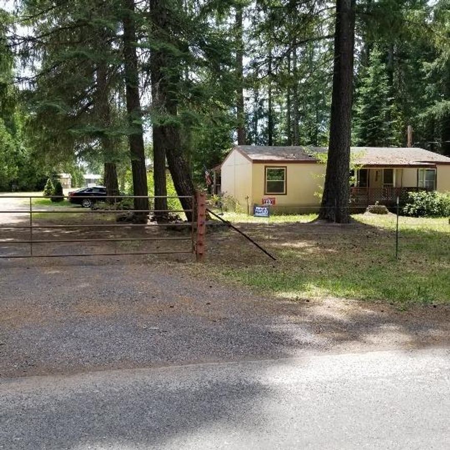 Nearly 3 acres of park like setting, split floor plan, vaulted ceilings with fans, bull nose corners, tape and texture, nice and bright inside. This home is in a great well area, amazing lush pasture to raise an animal or two. The home has a front and back covered porch runs the length of the home and has provided room for many fun times. Property has been completely mowed and cleaned and is ready for a buyer.