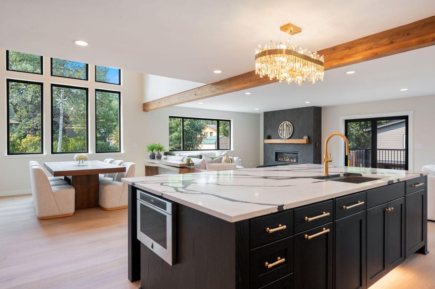 Welcome to 1026 NW Baltimore, a 3,540 SF luxury home fully rebuilt in 2025. Just one lot from Columbia Park and the Deschutes River—and walkable to downtown, the Galveston corridor, and the Old Mill—this home blends timeless design with modern comfort. The open floor plan features a chef's kitchen with a 9.5' island, custom cabinetry, walk-in pantry, quartz counters, and Jenn Air Pro appliances including double ovens, two dishwashers, and 48'' range with griddle. The great room centers on a linear fireplace with floor-to-ceiling herringbone tile, dining area, and views of open space. The primary suite offers spa luxury with heated tile floors, oversized shower, soaking tub, and custom closet. A 4th bedroom and full bath sit on the main, with a 675 SF basement bonus suite with radiant heat and full bath. Updates include new flooring, drywall, lighting, metal roof, landscaping, fencing, fire pit, decking, paved drive, and oversized 750 SF garage. A brand-new home in Bend's best location.