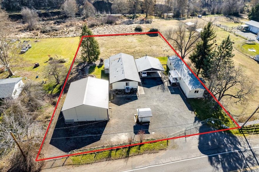 This property has it all! If you're looking for a 2 family setup w/ a shop on fully fenced land w/ irrigation, then this is it! Main home is frame built & offers 2 beds, 2 baths w/ recent updates, large laundry/mud room, new flooring & a great yard w/ raised beds. The 2nd home/possible guest quarters or potential mother in law residence is a 1989 manufactured home & also offers 2 beds, 2 baths, vaulted ceilings & has also been recently updated. Both homes are turn key & ready to move into or rent out! You'll love the big shop for projects & storage as well as RV parking + hookups & double carport w/ lockable storage rooms. Property has Little Butte Irrigation rights & small fenced pasture for animals. The best of both worlds w/ public water + 2 wells. A great investment property w/ potential income frm both homes & the shop or live in 1 home & rent the other. So many possibilities- don't miss out on this RARE opportunity!