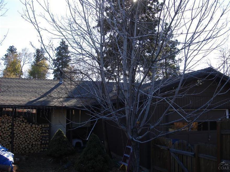 Great home in very desirable location at the base of Pilot Butte, just blocks from downtown. This lovely home features extensive custom tile work incl; granite tile kitchen & bathroom counter tops w/granite tile back splash, custom tile flooring throughout entire home except for 2 bedrooms, slate surround shower. Other features include excessive parking w/detached 2 car garage/shop, attached 1 car garage & carport, RV parking, & additional parking, nice back deck, large pantry, fenced front & back yard.