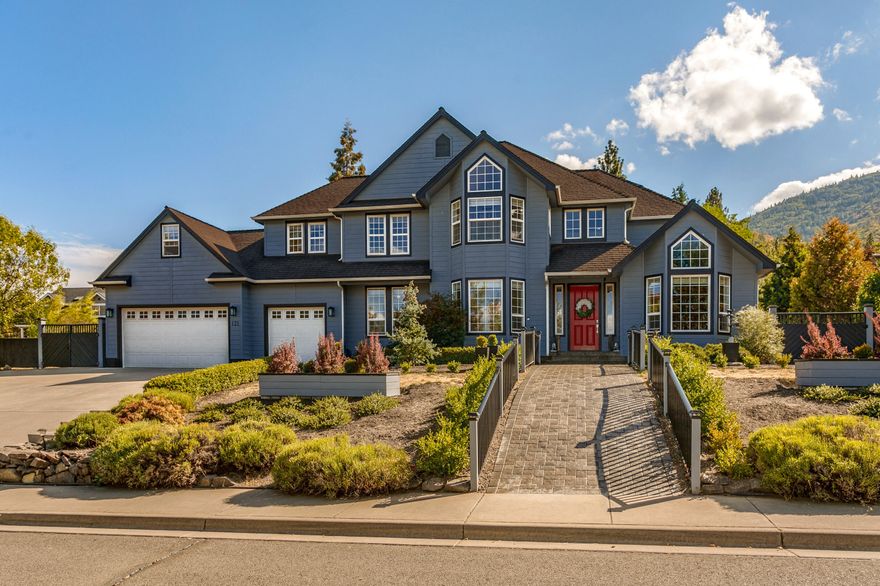 Spacious and elegant view home on a private half-acre lot with solar-heated pool, located in a desirable neighborhood near trails of Hald-Strawberry Park above Ashland's downtown plaza and Lithia Park. Main level with grand entry, high ceilings, oak floors, vaulted office with library shelving, living room with gas fireplace, kitchen with granite island and dining counter, gas range, dual ovens, dishwasher, Sub-Zero refrigerator, pantry, informal and formal dining areas, butler's pantry, half-bathroom, laundry room, and three-car garage. Four bedrooms, bonus room, and two full bathrooms with updated tilework on the upper level — including primary suite with dual quartz vanity, soaking tub, shower with skylight, and walk-in closet. Grounds include a tranquil water feature below the primary suite, concrete patios and pergolas, waterslide and new retractable pool cover, sunny gardening areas, and gated RV or boat parking. New HVAC with whole-home filtration in 2021. Inquire for details!