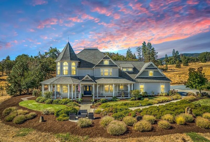 This beautiful Victorian estate is located on a private drive minutes from Jacksonville, providing a country feel with stunning views of the valley & Mt McLoughlin! You will find space for any hobby on nearly 6 acres w/ a 3 car garage, covered RV parking, heated barn, fully fenced established orchard & garden w/ irrigated raised beds, berry bushes, grape vines & chicken run. Upon entering this newly renovated home you are greeted w/ beautiful refinished hardwood flooring, integrated speakers, a gourmet kitchen w/ new stainless steel appliances & beverage bar. The primary suite offers extraordinary panoramic views, updated master bath, gas fireplace & walk-in closet. Two additional bedrooms, a full bath & large bonus room are also upstairs. The attached carriage house is climate controlled, approx. 1,200 sqft & perfect for a potential home office or second family set up. The spacious wraparound porch is ideal for entertaining or simply enjoying the sounds from the nearby Britt Pavilion!