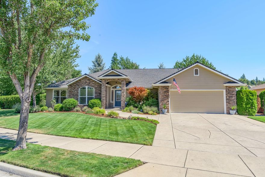 Beautiful single-level home in the Eagle Point Golf Community is immaculate inside & out!  Stacked stone exterior accents.  Large covered front porch.  Open great room floor plan with decorator/plant shelves throughout.  Attractive hardwood flooring.  Three-sided gas fireplace to enjoy from dining area, kitchen & great room.  Kitchen has vaulted ceiling, walk-in pantry, raised eating bar, granite counters & stainless-steel appliances including gas range/oven.  Bay window in dining area.  Large master suite offers slider to covered back patio, double-sink vanity, jetted tub, separate shower & walk-in closet.  Spacious guest bedrooms.  One guest bedroom has vaulted ceiling & built-in desk.  Laundry room has extra cabinet storage & drying rod.   Large covered back patio with ceiling fan.  Beautiful landscaping, garden beds & raised planters too.  Built-in cabinets in garage plus utility sink.    Maximum curb appeal for this .30-acre lot!