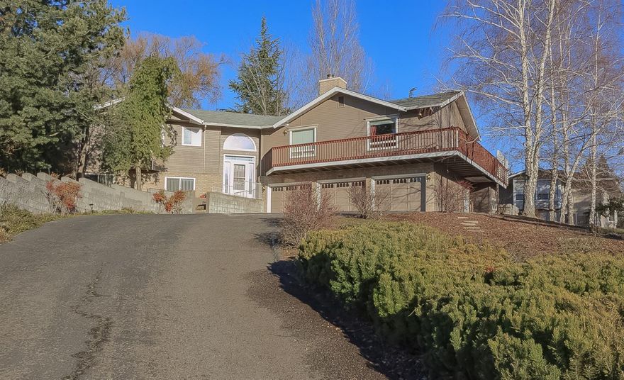 Spacious home with wrap around decks to capitalize on the beautiful Valley Views, home was custom designed w/ gorgeous cabinets and lots of built-ins with storage galore. Main floor master bed/bath suite with double door entry, boasts large soaking tub and separate 5 ft shower, deck access to hot tub, plus 2 additional bedrooms on main level level. Well planned kitchen with spacious built-in pantry, breakfast room w/granite top side board & coffered ceiling - with access to covered deck & private rear yard w/ 30 ft. man made stream w/2 water falls cascading into private pond, solar powered greenhouse, and terraced garden area. Large living room with vaulted ceiling and cozy gas fireplace. Downstairs has an oversize media/bonus room or could potentially be a 4th bedroom. Additional tile floored workout/craft room, 3 car garage.& RV parking.