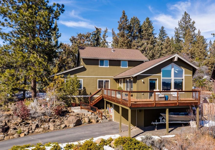 Perched above the river with wide-open views of the city to the mountains beyond, this lovely NW Bend home offers a prime location & private setting. Open great room with large windows & south-facing front deck take in the vistas. A double-sided fireplace adds warmth & charm. Main level master & office, 3 additional bedrooms upstairs. Updated kitchen with farm sink, concrete counters & breakfast bar. Wonderful fenced back yard, perfect for pets & play. Located on a double lot less than a mile from downtown Bend & close to the river trail. County records show home built in 1971. Home was enlarged, substantially rebuilt in 1995.