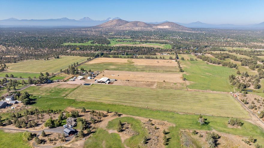 Experience 20 prime Central Oregon acres near the Deschutes River and Cline Falls State Park. With irrigation rights and panoramic mountain views, this property sets the stage for your dream home. Meticulously maintained, it's fully outfitted for horses and livestock, featuring fencing and cross-fencing throughout, along with thirteen acres of hay production. Equestrians will appreciate the impressive 8,400 SF covered riding arena, complete with 5 stalls. The grounds also include hay storage, a 48' x 48' pole-building shop equipped with water and 220 power, and a lean-to offering four additional stalls. Practical amenities abound—RV parking and storage, a well with a recently updated pump house, and a pond upgraded with all new equipment. Every detail has been thoughtfully taken care of, making this the perfect canvas for building the home you've envisioned.
