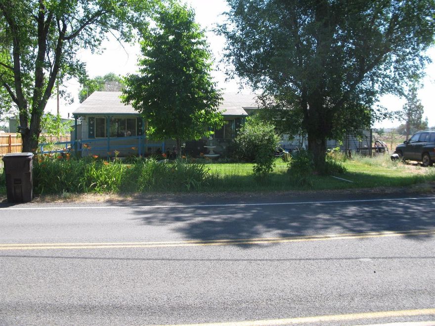 Wonderful small irrigated acreage with 2 tax lots. Lots of possibilities here, work and live in the same place. House is a 3 bedroom, big living area. COI irrigation 1.5 acres. Easy access to HWY 97, close to town, yet country. 2 separate tax lots, good potential. Has canal frontage and walking bridge. Property being sold as-is.