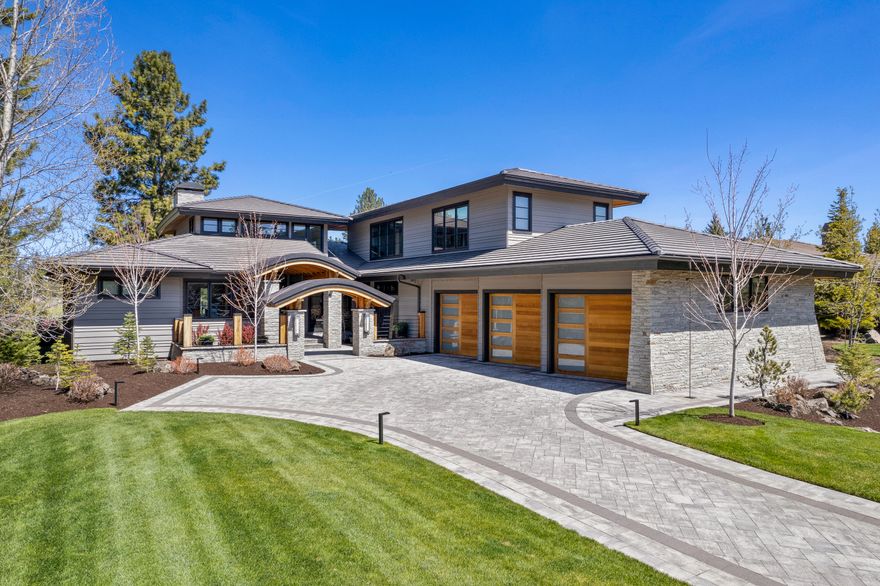 Come experience the tranquility and craftsmanship in this stunning contemporary home located in the desirable gated community of Broken Top. A home that truly has it all, this beautiful and inviting entry water feature just may have you sitting on your front porch all day. Upon entering the home, you'll notice the abundance of windows letting light and views of the course stream in. The spacious great room with stunning fireplace flows into the kitchen that lacks no attention to detail. The expansive kitchen island, custom pullout wall pantry, cooktop, double ovens, wine frig, and two sinks all make this a well-appointed kitchen. Hunter Douglas automated shades
throughout. Sonos sound system throughout the inside and exterior. Enjoy our Central Oregon evenings under the covered patio which includes overhead heaters, a built in Wolfe BBQ and dining area. Main level living includes a den, office, exercise room, two primary suites, one that boasts it's own sauna.