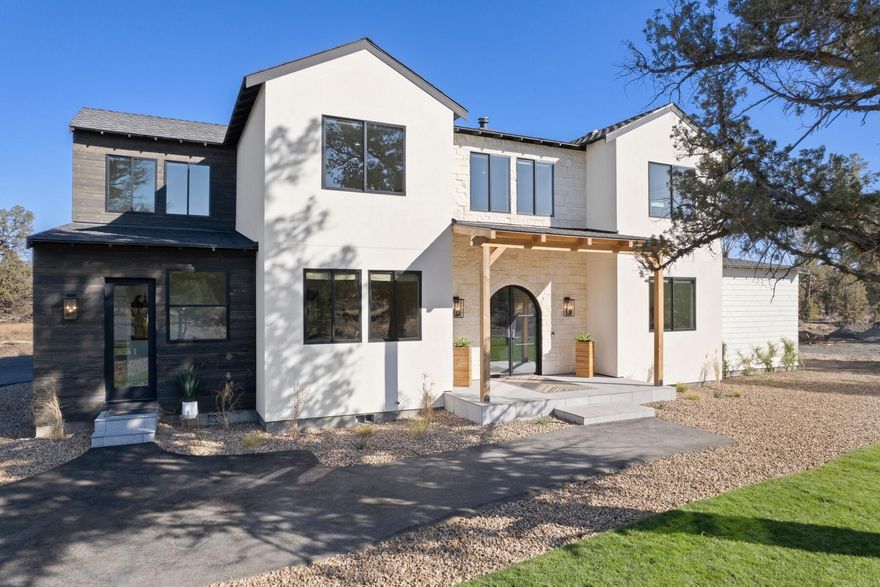 This Modern Mediterranean vision defines sophisticated luxury living in a serene oasis. The custom-built 3,725-sq-ft home includes an arched steel entry door, open floor plan, 8-inch white oak floors, designer finishes, premium windows & doors, & upgraded insulation. The chef's kitchen boasts white oak custom cabinets, Dacor appliances & quartz waterfall island, counters & backsplash. The primary suite on the main includes bath with oversized shower, quartz countertops, distinctive  wallpaper, large-format tiles & white oak cabinets. Upstairs includes 4 bedrooms with walk-in closets, plus a 16X30 bonus room & 2nd washer/dryer. Set on a 10-acre corner lot, the property is fully fenced & has a 96X72 outdoor arena, two 1-acre paddocks & a half-acre pasture with underground irrigation. There are multiple electrical panels on the property ready for future development. The 3-car garage has RV hookup & 2 electric car chargers. The large back patio leads to a fully furnished 24-ft tipi.