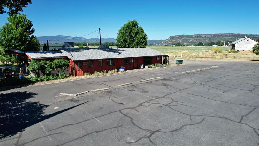 The Touvelle Lodge is a popular tavern with a dedicated local customer base, ideally located on 1.91 acres zoned RS (County-Rural Service Commercial) and enjoying a daily traffic count of 7,800 cars. This turn-key 2,140 sq. ft. bar includes a covered patio, band stage, and offers both indoor and outdoor seating with an outdoor bar and patio area. Recent renovations with new flooring, upgraded bathrooms, and a new roof, the property ensures modern comfort and durability. Patrons can enjoy live music during summer months, and the site features an RV pad with water and power hookups, an 800-sq. ft. shop with a 14-foot door and 20-foot ceiling on a concrete slab, a well with a 2000-gallon holding tank, and ample blacktop parking. The property is securely fenced, making it a versatile and appealing opportunity for investors or entrepreneurs searching to tap into an established business with significant growth potential. Owner will carry.