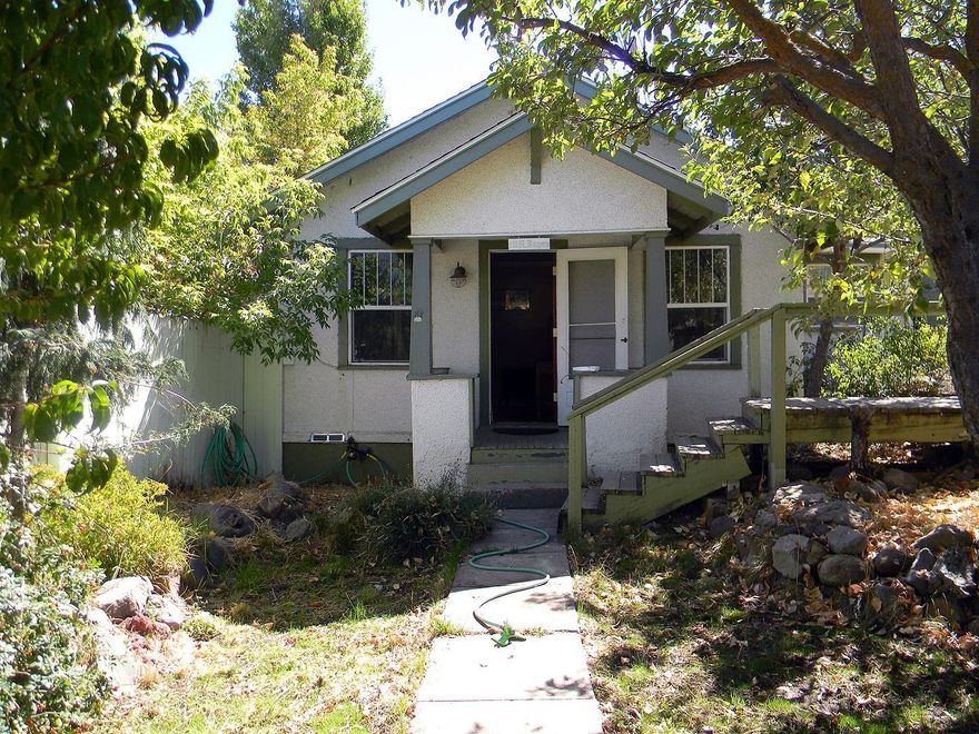 Adorable craftsman cottage with tons of upgrades and unique features everywhere! New electrical throughout the entire house and garage in 2009, fresh paint, vinyl windows and high quality insulation to name a few. All hardwood floors and tile in the kitchen, with a breakfast nook and built in shelves all over the home adding additional storage opportunities. Large bedroom and bathroom in this very well maintained and charming home. Very private yards with fruit trees of all kinds everywhere, fully fenced backyard, garden area, greenhouse, no mow no water backyard and a covered patio perfect for entertaining. This little house has a great layout, is in great condition and is perfect for college students, first time home buyers or whoever. Don't miss out on touring this one!