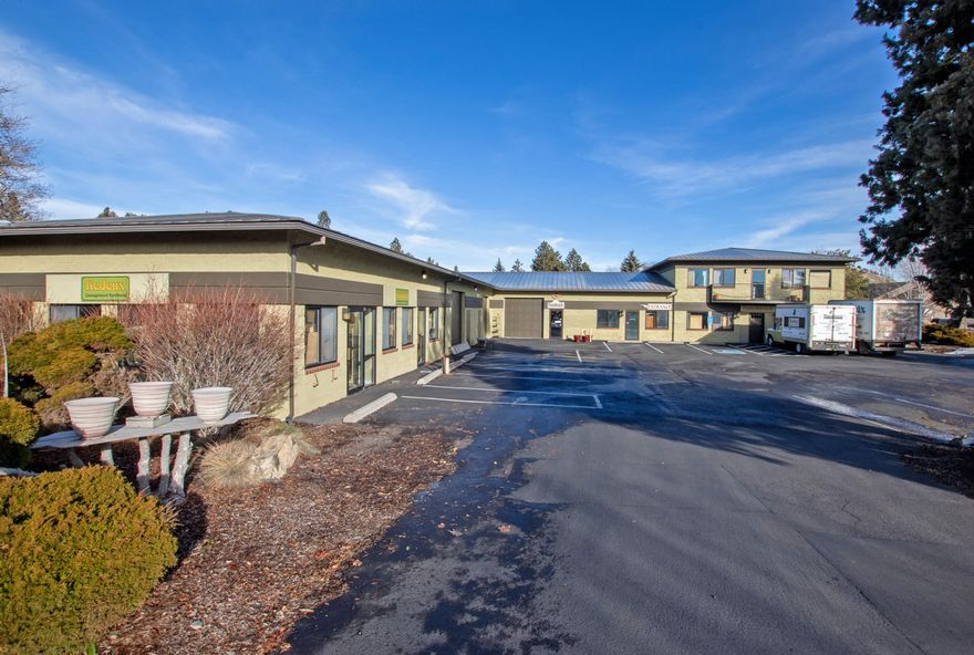 PRICE REDUCED! Seller Financing Available! Discover the exceptional potential of this premier industrial property primed for owner-user success. This versatile space features a spacious warehouse layout complemented by convenient second-floor offices, catering to a diverse range of business requirements. With masonry walls and a resilient metal roof, this property ensures durability and longevity with minimal maintenance demands. The building has three grade-level roll-up doors, multiple restrooms, Reznor heaters, and forced air heating and air conditioning systems. Situated within Bend's Eastside Business and Industrial Park, the property enjoys a strategic location known for its business-friendly environment and accessibility, further amplified by its prominent monument sign offering exceptional visibility.