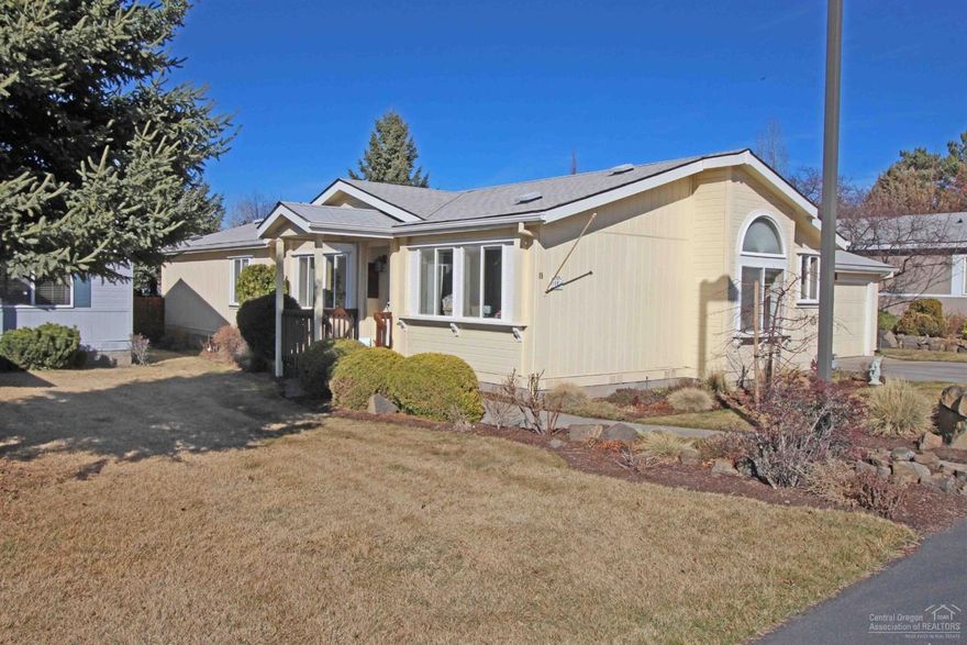 Beautiful 55+ deep in Snowberry Village far away from the sounds of 27th St. A wonderful layout & one of the largest homes & largest yards in Bend's premier 55+ park. Sharp, clean & move in ready. Eat-in kitchen with loads of cabinet space & tile back splash. Ceiling Fans. Formal dining room. Refrigerator, Maytag Washer & Dryer included - both 6 years old. Dishwasher 2 years old. Deep sink & more storage in utility room. Two bedrooms but home includes an office that <b>you could use as bedroom </b>(add your own closet). Master has walk in closet PLUS a second closet & huge master bath with upgraded Tile shower. Natural gas appliances & central AC. Two car garage is larger than typical in the park. Large fenced yard with patio &<b>covered back deck! </b>Near medical community & lots of shopping. Walk to grocery store! Regular resident-run clubhouse activities. $535/mo space rent includes water, sewer, front/side mowing street snow removal & clubhouse. No rentals allowed in Snowberry Vil